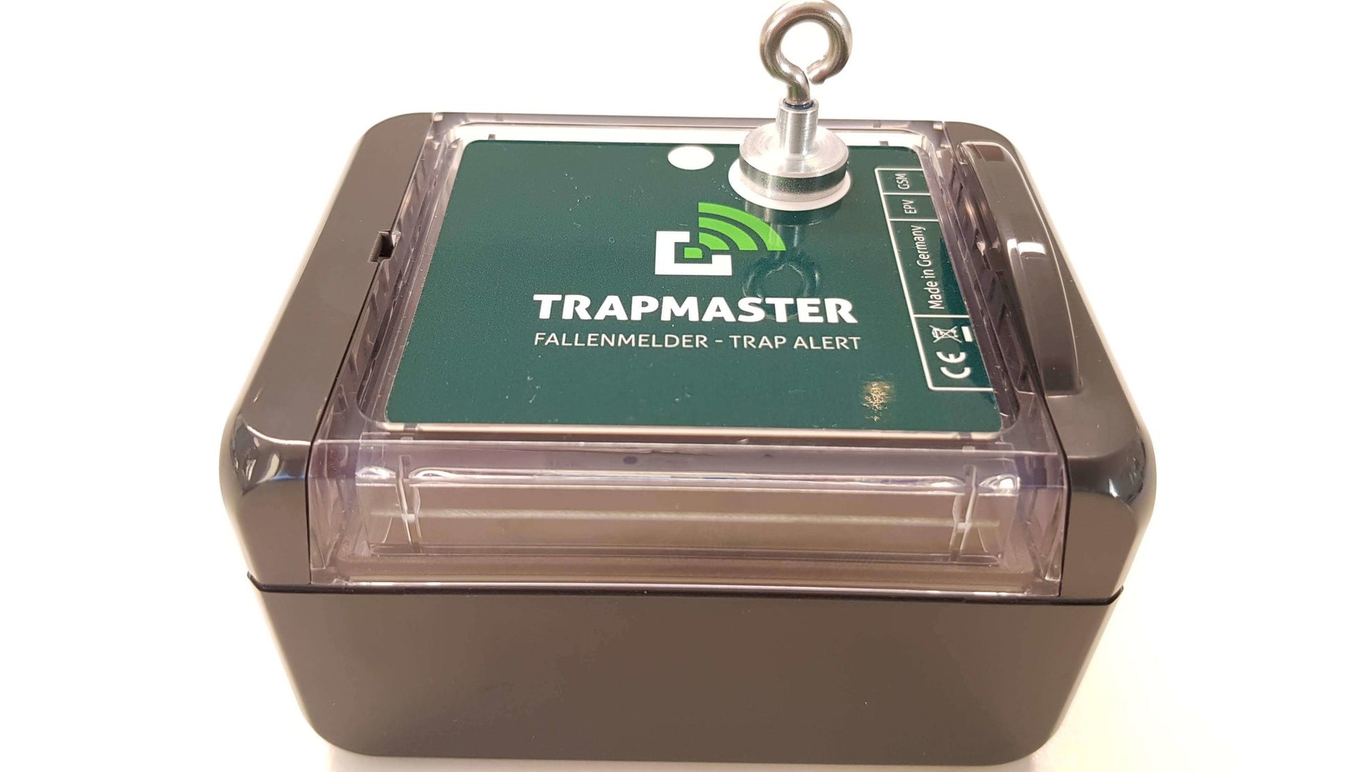 Der Magnet wird zur Auslösung oder Aktivierung des Geräts verwendet. Das grüne Bedienfeld mit Beschriftung und LED-Anzeige ist durch eine transparente Abdeckung geschützt.